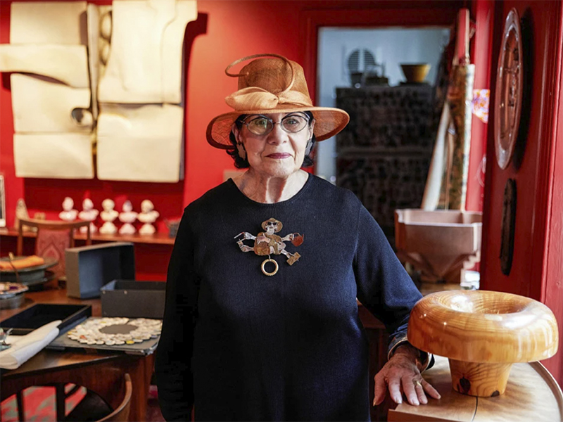 Helen Drutt wearing a brooch by Merrily Tompkins